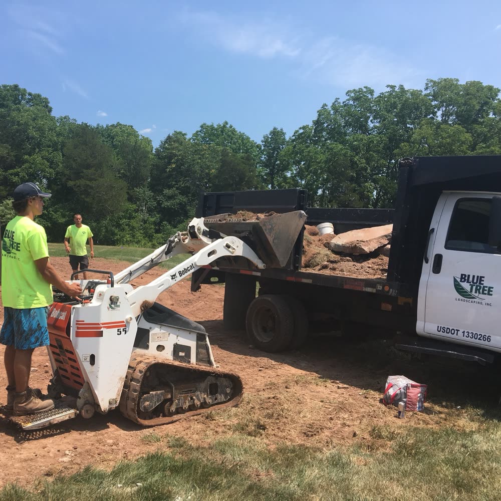 Blue Tree landscaping crew and equipment on a job site.